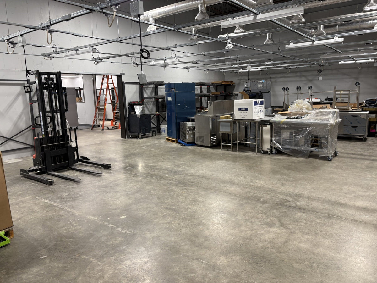 T40 busway grid with power drops and lighting across the same project space during installation