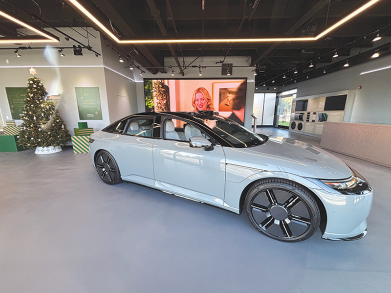 Overhead Track Busway power and lighting system enabling flexible layouts in an automotive showroom.