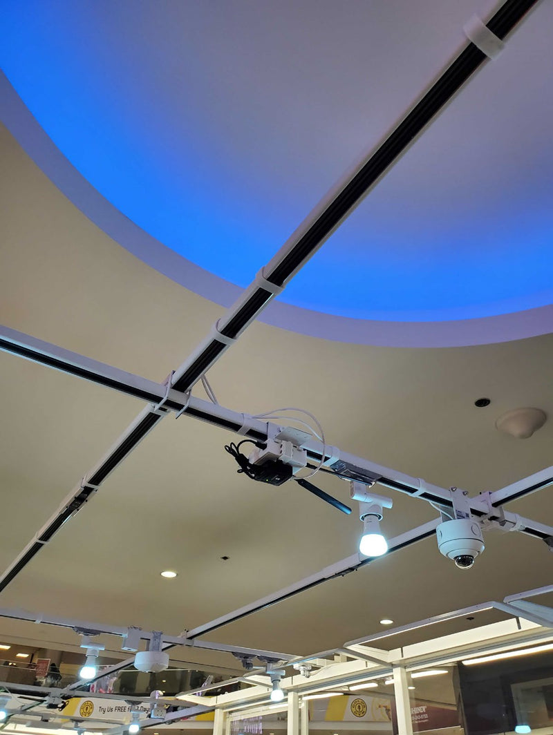 track busway grid with low voltage gateway and security camera and lighting all resting on kiosk