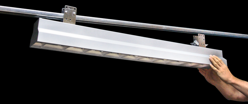 Plug-in linear lighting fixture mounted to Track Busway in an industrial manufacturing environment
