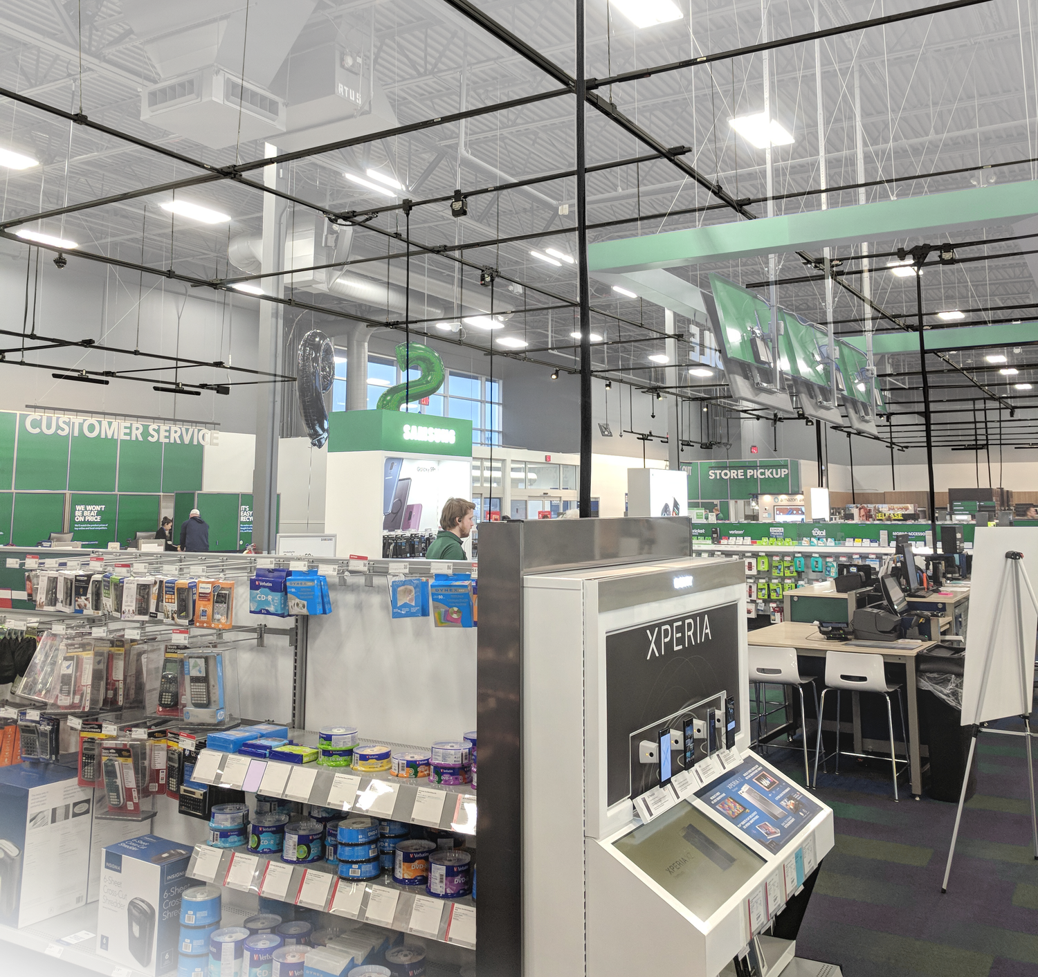 Track Busway overhead system in retail environment showing integrated power distribution, lighting, and data infrastructure suspended above open ceiling workspace